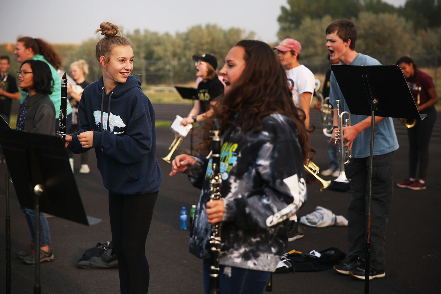 Cora Turner laughs as she leans back and forth with the rest of the pep band